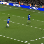 **

A tense moment during a soccer game. An attacking player in an offside position, with the VAR lines clearly visible on the screen overlayed on the field. Focus on the anticipation and scrutiny of the offside call. Add Japanese text to the display, like "オフサイド判定" (Offside Determination).

**